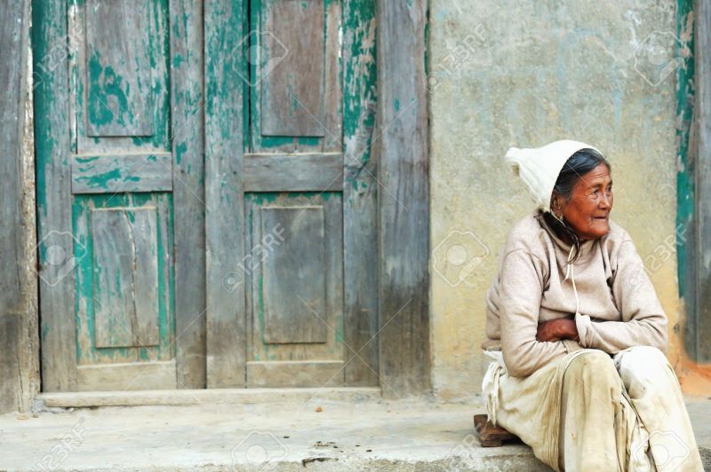 Woman sitting before her house. Godawari-Nepal. 0968